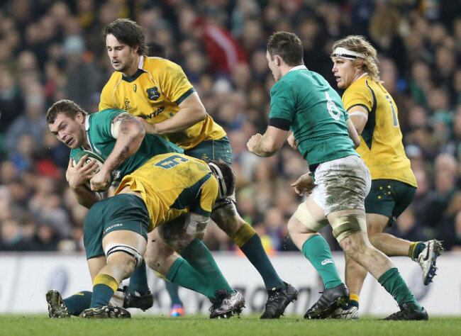 Jack McGrath is tackled by Luke Jones and Sam Carter