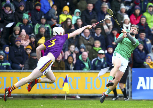 Peter Casey shoots under pressure from Liam Ryan.