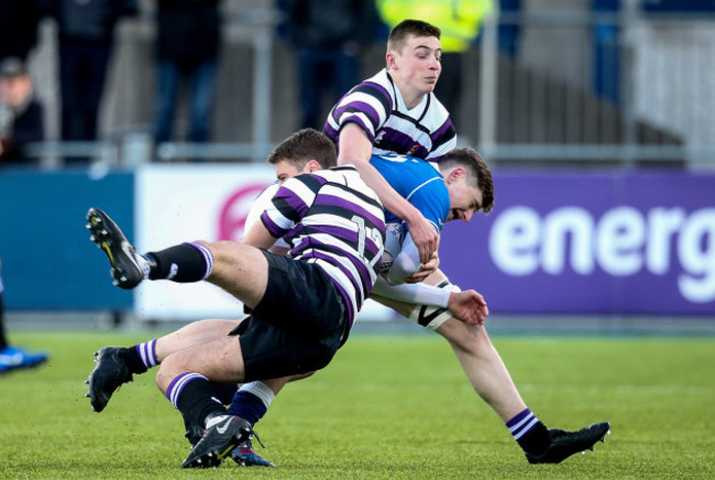 Jack McSharry is tackled by Henry Roberts and Tom Ruane