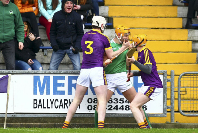 Seamus Flanagan tussles with Shaun Murphy and Liam Ryan