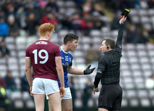 Derek O'Mahoney shows a black card to Peter Cooke and Killian Brady