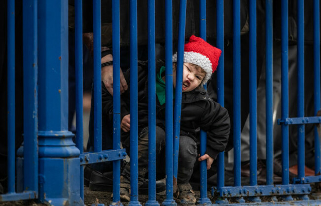 A young boy tries to get a better view of the races at Leopardstown