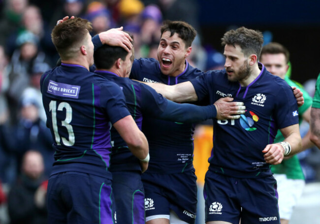 Sam Johnson celebrates his try with Huw Jones, Sean Maitland and Tommy Seymour