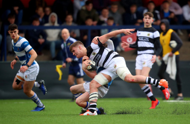 Alex Kendellen is tackled by Eddie Daly