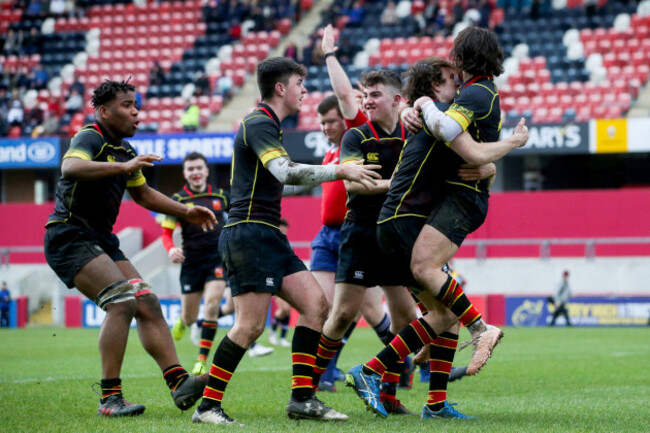 Killian Dineen celebrates scoring a try with teammates