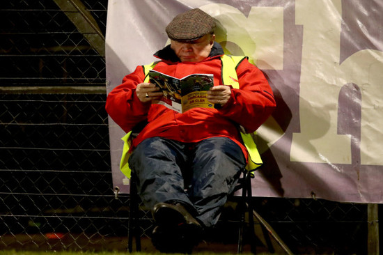 Steward Dan Cronin reading the match program