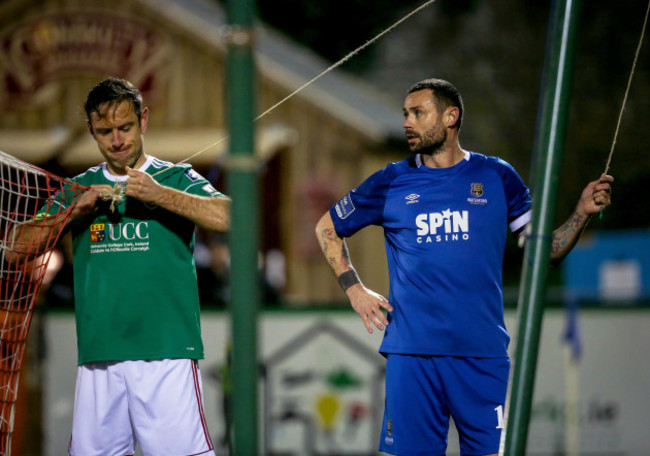 Alan Bennett and Damien Delaney fix the goal net during the game