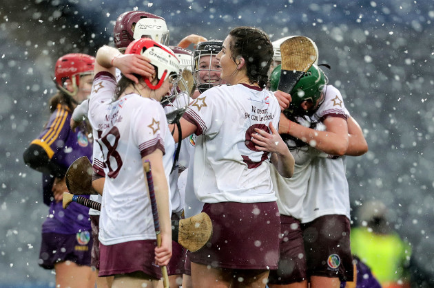 Niamh Glass and Faoiltiarna Burke celebrate with teammates