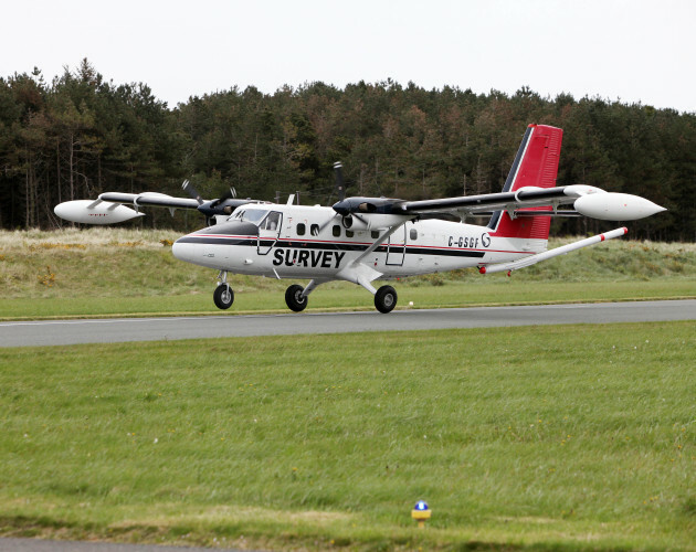 Low Flying Plane Carrying Out Surveying Mission Across - 
