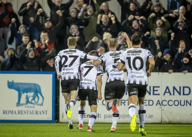 Dundalk players celebrate Michael Duffy's goal with the fans