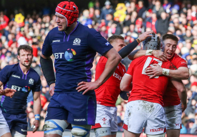 Jonathan Davies celebrates scoring their second try with Josh Adams and Gareth Anscombe