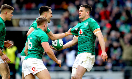 Jonathan Sexton celebrates scoring their second try with Jordan Larmour and Conor Murray