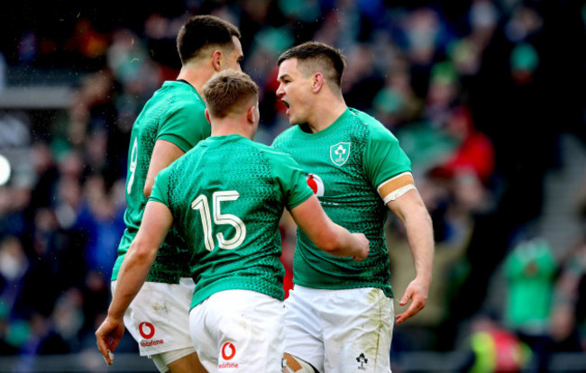 Jonathan Sexton celebrates scoring their second try with Jordan Larmour and Conor Murray