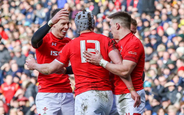 Jonathan Davies celebrates scoring their second try with Josh Adams and Liam Williams