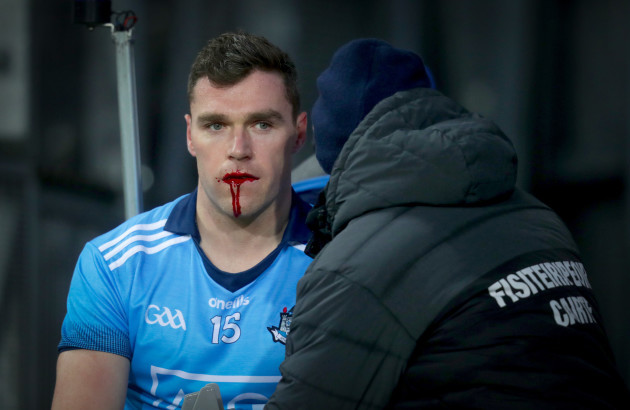 Paddy Andrews is taken off with a blood injury