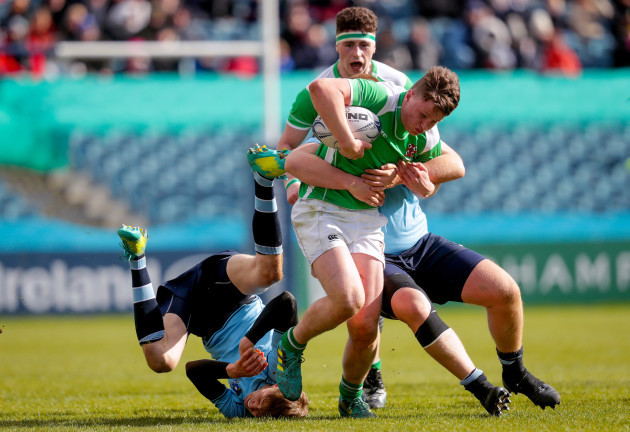 Ronan Shaw is tackled by Niall Carroll and Fionn Finlay