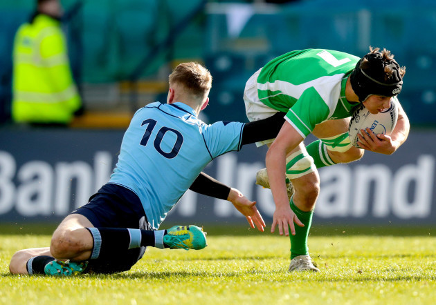 Tom Cullen is tackled by Niall Carroll