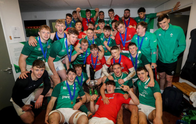 Ireland players celebrate with the trophy in the dressing room after the game