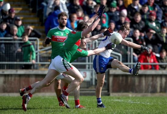 Jack McCarron comes under pressure from and David Drake and Stephen Coen