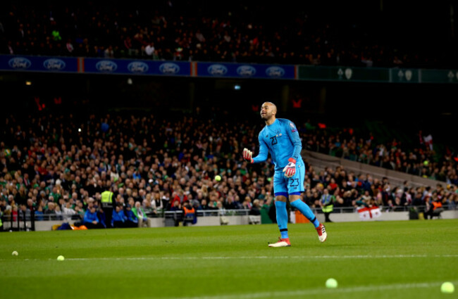 Darren Randolph removes tennis balls from the field