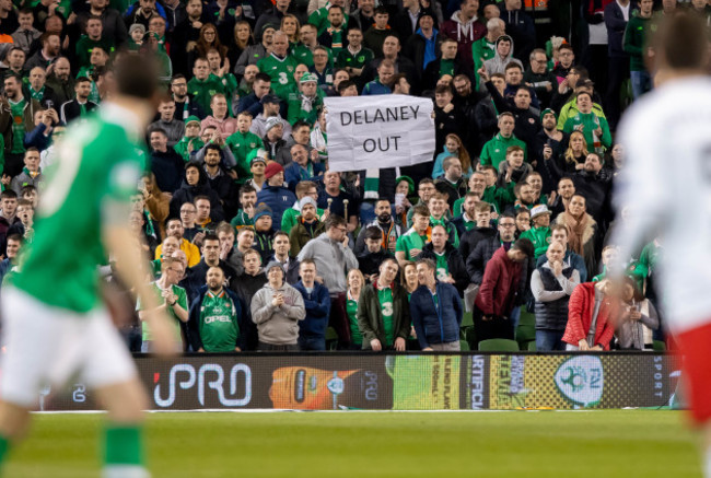 A fan holds a banner in protest of FAI Executive Vice President John Delaney