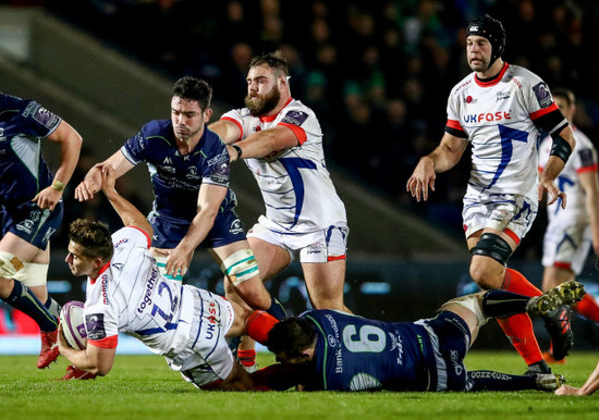 Rohan Janse van Rensburg is tackled by Eoghan Masterson and Paul Boyle