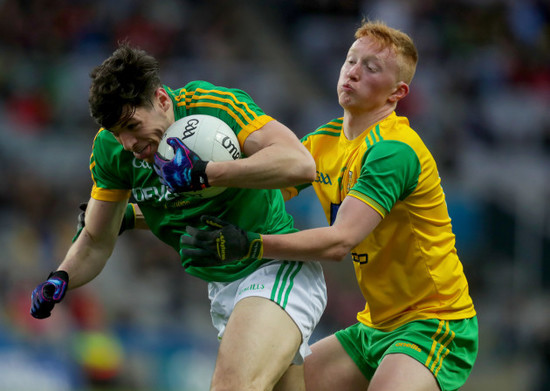 Seamus Gavin is tackled by Oisin Gallen