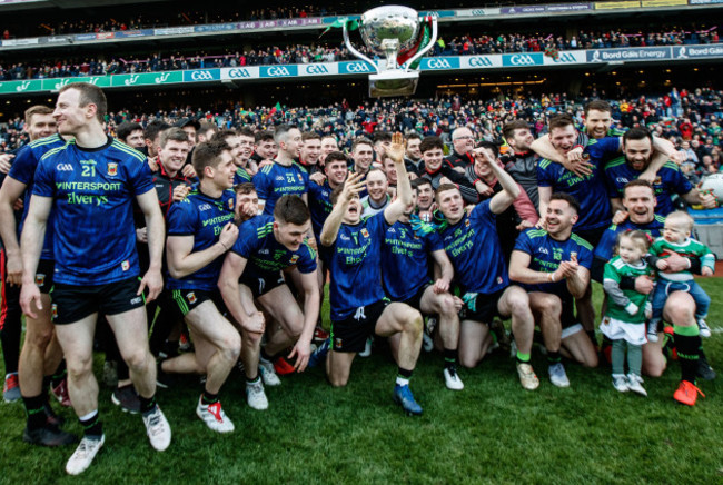 Fergal Boland celebrates by throwing the trophy