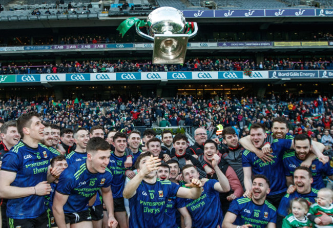 Fergal Boland celebrates by throwing the trophy