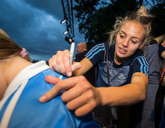 Nicole Owens signs a jersey