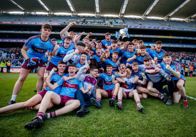 St. Michael's College celebrate with the trophy after the game