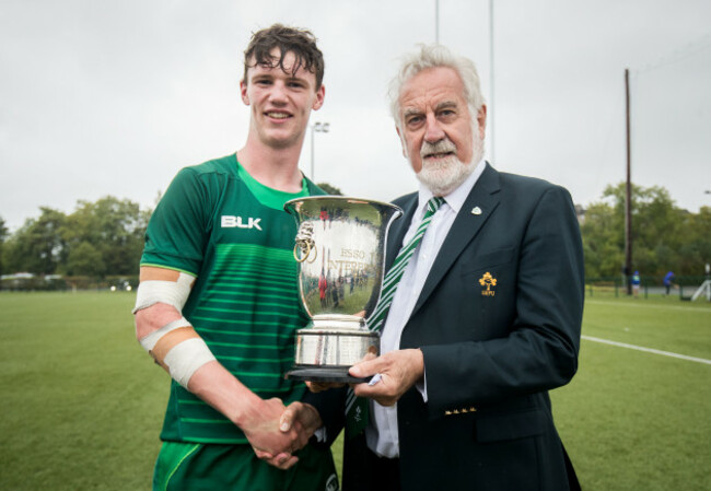 Darragh Murray receives the trophy from Adrian Leddy