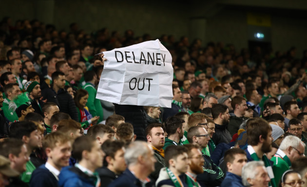 Fans hold signs in protest of FAI Executive Vice President John Delaney