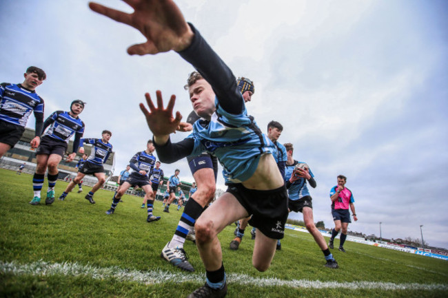 Colin Counihan is tackled into touch by Ryan Gaughan