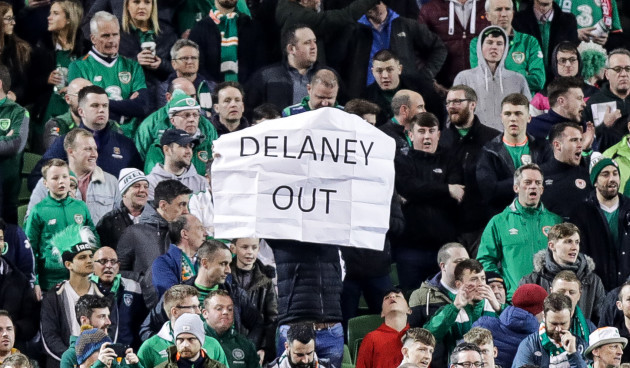 A fan holds a banner in protest of FAI Executive Vice President John Delaney