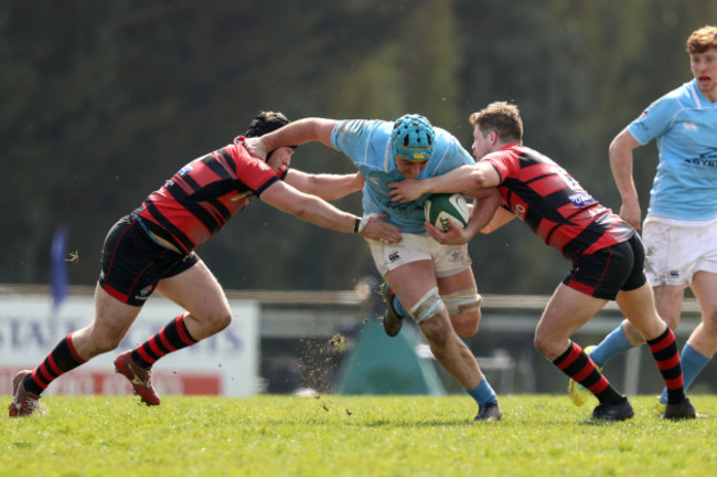 Kevin Seymour is tackled by Andrew Smyth and Chris Colvin