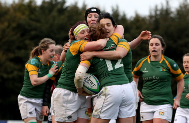 Meg Kendal celebrates scoring a try with team mates