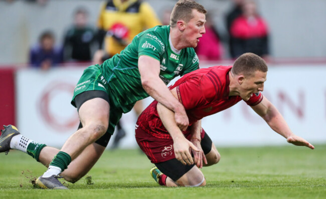 Stephen Fitzgerald dislodges the ball from the arms of Andrew Conway
