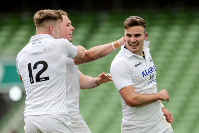 Shane Daly celebrates scoring a try with Alex McHenry and Sean French