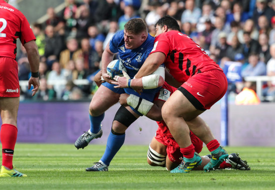 Tadhg Furlong is tackled by Maro Itoje and Titi Lamositele