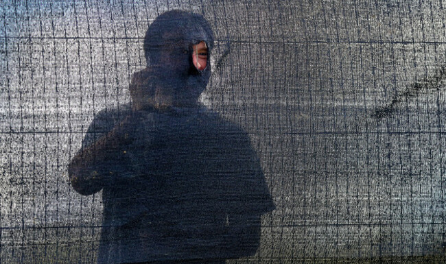 A spectator from outside the grounds looks in