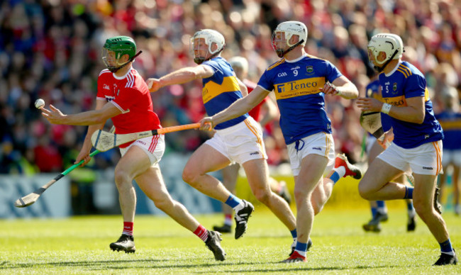 Seamus Harnedy tackled by Padraic Maher and Michael Breen