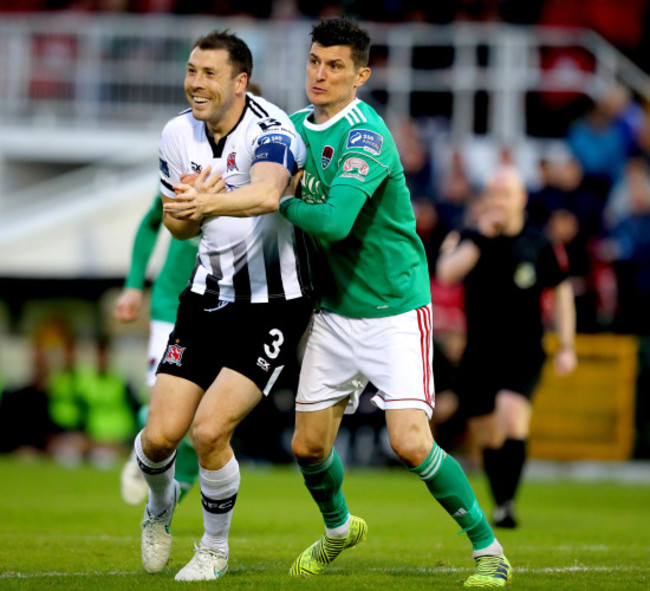 Graham Cummins tussles with Brian Gartland off the ball