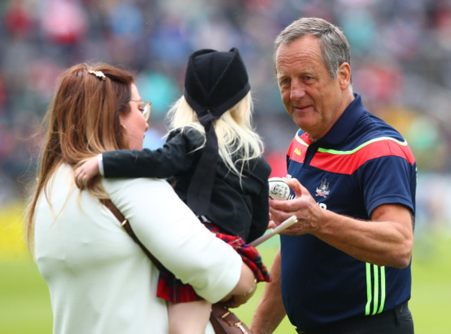 John Meyler gives a little girl a sliotar before the game after she was accidentally knocked over by a player