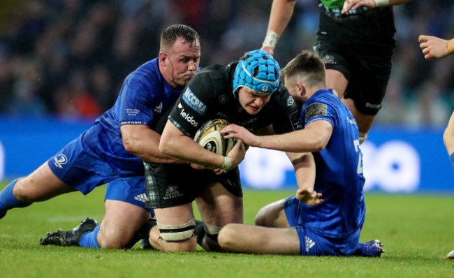 Glasgow Warrior's Scott Cummings is tackled by Leinster's Bryan Byrne and Ross Byrne