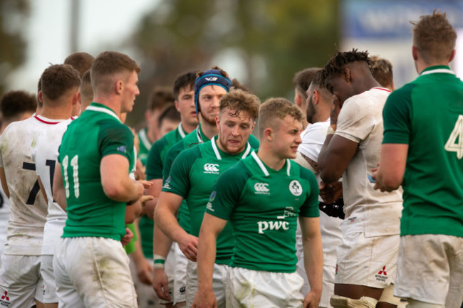 Ireland players celebrate winning as the England team clap them off the pitch