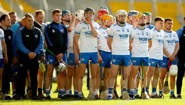 The Waterford team stand alongside the management  and substitutes during the anthems