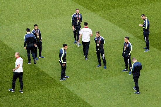 Gibraltar players inspect the pitch ahead of the game