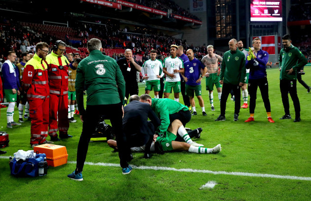 Ireland players look on as Alan Judge receives treatment