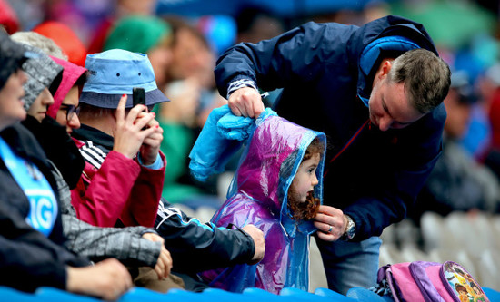 A young Dublin fan has her raincoat adjusted